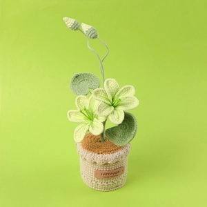Macro detail of handmade crochet flower in a pot with a leather handmade label