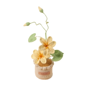 Handmade crochet potted yellow flowers with green leaves in a woven pot home decor
