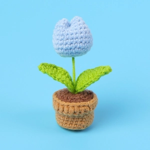 Close-up of handmade crochet blue tulip potted plant with delicate yarn textures