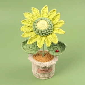 Detail of handmade crochet sunflower plant with tiny ladybug and handmade label