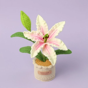 Detail of pink and white crochet lily flower with handmade leather label on base