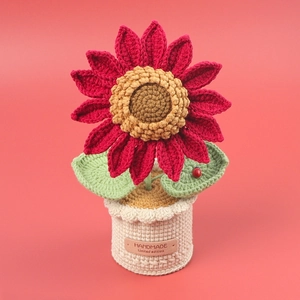 Handmade crochet sunflower potted plant with red petals and green leaves for desktop decor