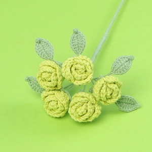 Bouquet de 5 roses jaunes au crochet avec feuilles vertes sur fond vert uni