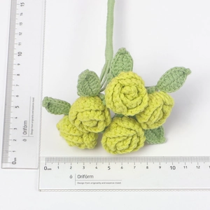 Détail de cinq têtes de roses crochetées à la main jaunes avec mesures sur fond blanc