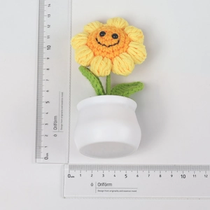 Size measurement of handcrafted crochet sunflower plant with smiling face in white pot
