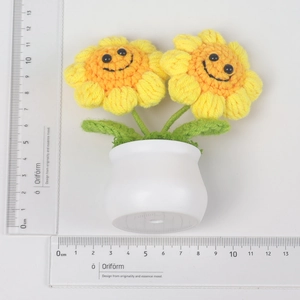 Top view of handmade knitted sunflower potted plant showing dimensions with a ruler