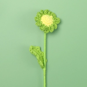 Macro detail of handmade crochet daisy flower with intricate yellow and green wool textures