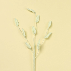 Detailed macro view of handmade crochet green leaf sprig with knitted texture for decor