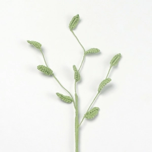 Detail of handcrafted crochet green leaf branch for floral arrangements and home decor