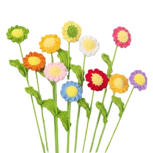 Handmade crochet daisy bouquet in vibrant colors with knitted petals and green stems