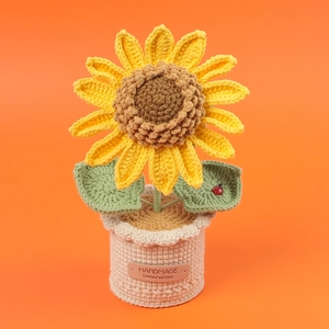 Detail of crochet sunflower with ladybug decor and HANDMADE leather label on beige pot
