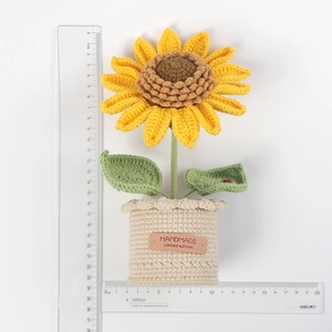 Detail shot showing 21cm height of handmade crochet sunflower pot with measurement rulers