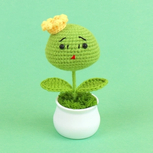Cute handmade crochet potted plant with green sphere, yellow flower and white base