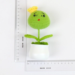 Handmade crochet plant doll in white ceramic pot with ruler showing 15cm height