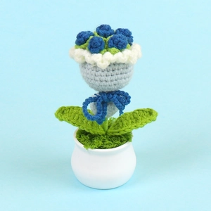 Handmade blue crochet rose flower in ceramic pot for desk or home decoration