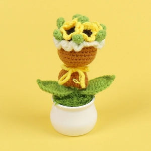 Detailed knit texture of a handmade crochet sunflower in a white ceramic pot