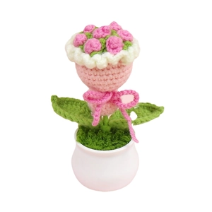 Handmade crochet pink rose flower pot with white scalloped edge and pink ribbon bow