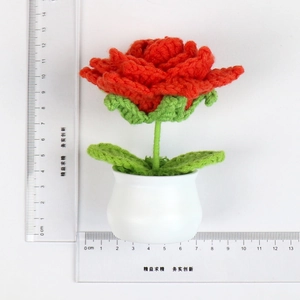 Handmade crochet red rose in white pot with measurement ruler showing 12cm height