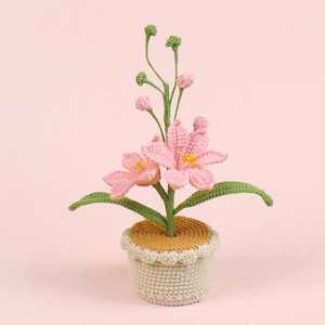 Handmade crochet pink lily potted plant with green leaves and cream knitted base ornament