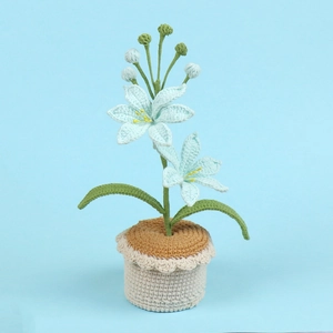 Detailed view of handmade crochet lily potted plant with blue petals and a beige pot