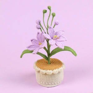 Handmade crochet potted Mars Orchid with purple flowers and green leaves on soft background