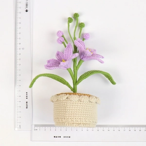 Detailed top view of handmade purple crochet lily in a beige pot with size measurement