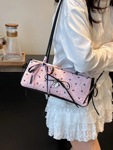 Borsa sottobraccio rosa in seersucker con fiocchi ricamati e ciondolo a cuore