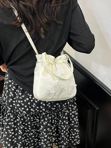 Chic embroidered butterfly bucket bag in creamy white with drawstring and shoulder strap