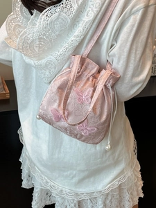 Pink embroidered bucket bag with butterfly 3D appliques and pearl drawstring charms