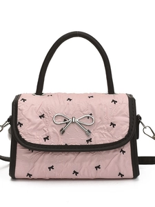 Pink quilted crossbody bag with black bow prints and a silver metal bow clasp