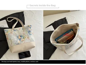 Dettaglio interno della borsa tote ricamata che mostra la capienza per iPad e libri