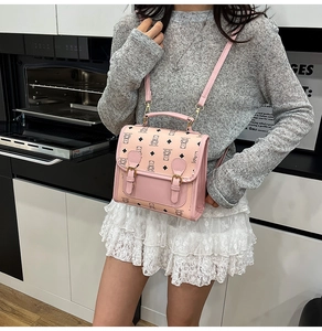 Pink cartoon bear print crossbody bag shown worn with casual grey and white outfit