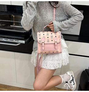 Pink cartoon bear monogram small square bag with top handle and strap in kitchen setting