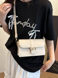 Chic cream white crocodile pattern shoulder bag with a unique bamboo style metal buckle