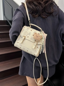 Chic cream bear print backpack with adjustable straps and cute teddy charm accessory