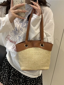 French vintage straw tote bag with brown faux leather trim and round metal ring accents