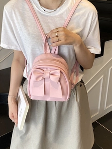 Minimalistischer hellrosa Mini-Rucksack für Damen mit großem dekorativem Schleifen-Design