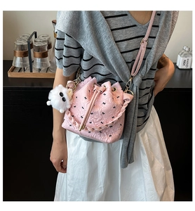 Detailansicht der rosa Falten-Beuteltasche mit Schleifen-Print und weißem Pompon