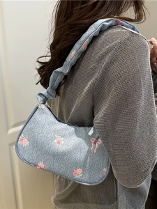 Light blue denim shoulder bag with pink rose and bow prints and ruffled strap