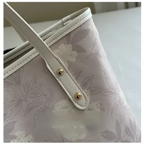 Close-up of floral tote bag showing high-quality stitching and gold rivet details