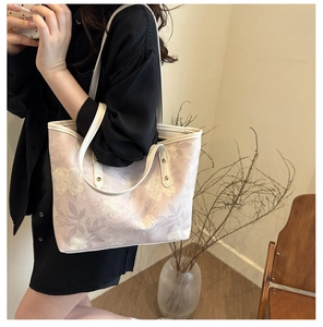 Floral print tote bag detail showing white leather straps and elegant floral patterns