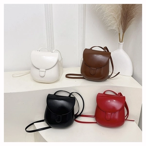 Detailed arrangement of shiny PU leather saddle bags in white, brown, black, and red