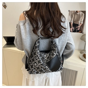 Detailansicht des geometrischen Jacquard-Musters und der Leder-Patches an der Umhängetasche