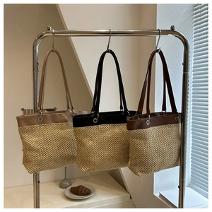 Detailed macro view of woven mesh tote bags hanging on a modern minimalist display rack