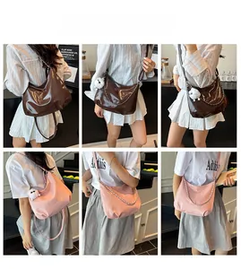 Detail showing crescent tote bags with metal chain and plush rabbit charm in two colors