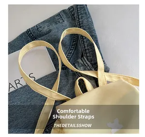 Detail of comfortable shoulder straps on a light yellow backpack with canvas texture