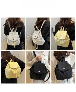 Detail view of fashion drawstring backpacks with rabbit logo in solid and plaid patterns