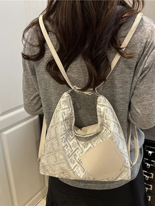 Elegant silver jacquard shoulder bag with chic floral pattern and leather patch detail