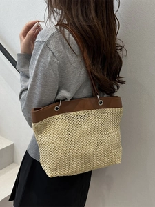 Vintage woven straw tote bag with brown leather handles for summer vacation style