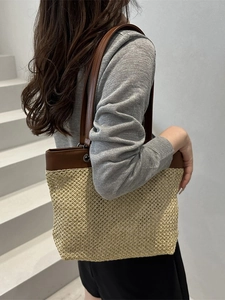 Retro woven straw tote bag with brown leather handles, perfect for summer vacations
